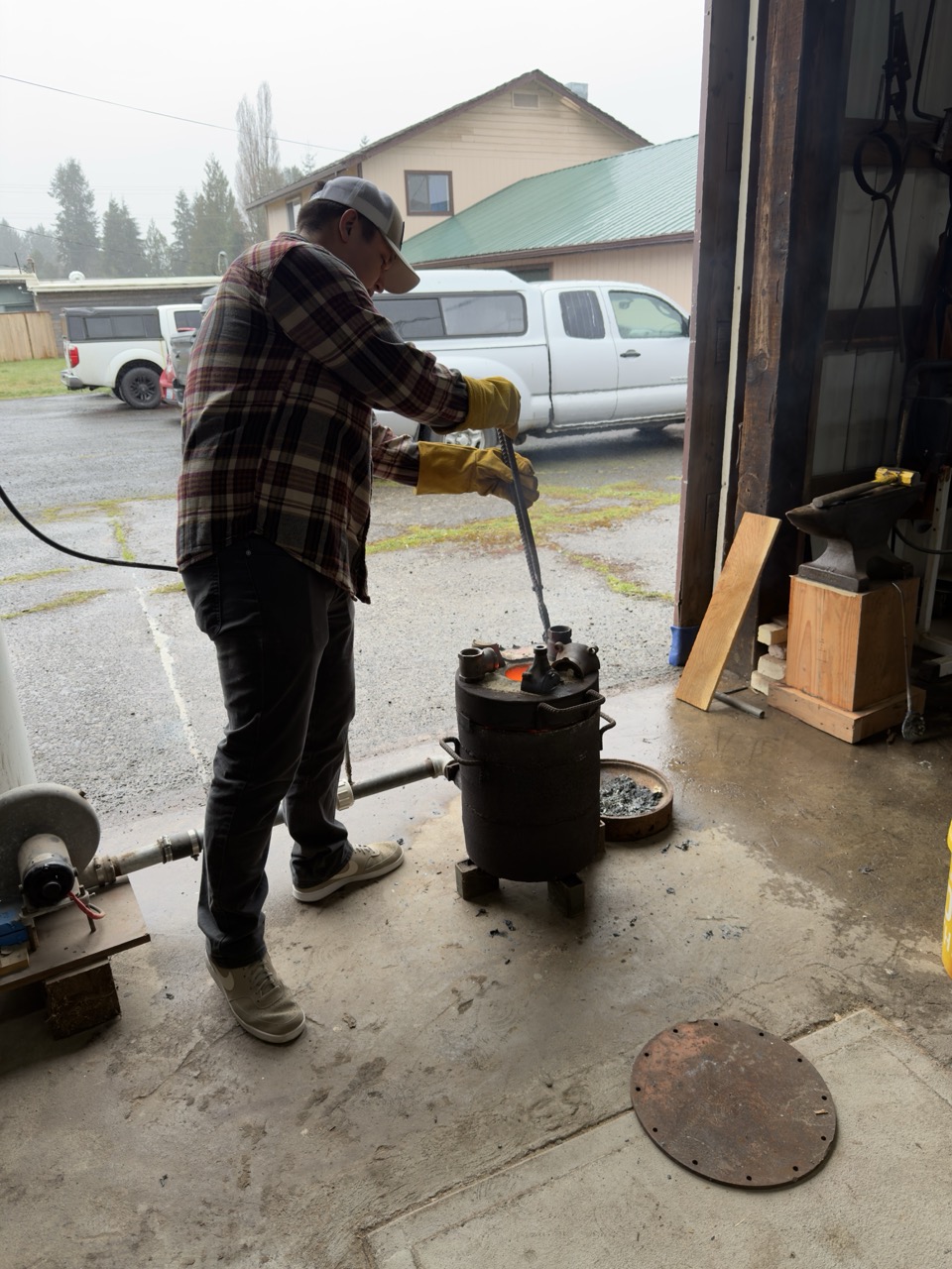 A man putting metal into the furnace