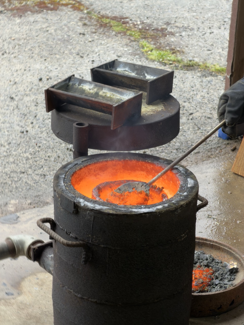 A ladle inserted into the crucible